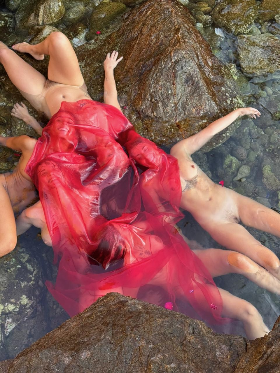 Naked women floating in water
